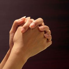 two hands holding each other in prayer