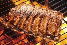 steak on the grill with flames in the background