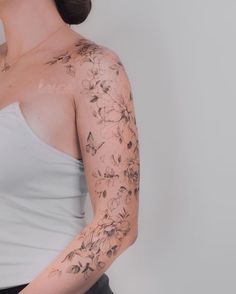 a woman with tattoos on her arm and shoulder