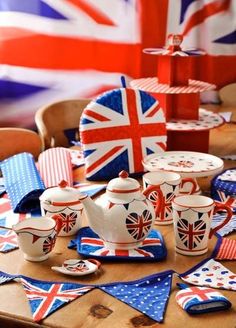 the table is covered with british flags and teapots