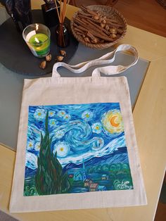 "100% handmade bag  100% handpainted  Van Gogh Women Canvas Tote Bag, The Starry Night Shoulder Bag Gift For Women, Impressionism Shopping Tote Bag Gift for Mom. Measuring at 16\"h x 14\"w (40cm x 35cm ) and with a handle length of 25.5\" (65 cm), these tote bags are with 100% linen canvas fabric. The bag has reinforced handle stitching for durability.  100% handmade bag  100% handpainted  Material: 100% natural linen canvas fabric  One size - 16\"h x 14\"w (40cm x 35cm)  Handle length - 25.5\" (65 cm)  Care Instructions:  Hand painted with special paint for textiles.  For the best preservation of the paint wash by hand.  You can machine wash separately: cold (max 30C or 90F), gentle cycle;  Tumble dry: low heat;  Do not iron directly over the painted area, it may stick to the iron.  Color Artistic Shoulder Bag With Artwork For Gifts, Artistic Hand Painted Shoulder Bag For Gift, Artistic Hand Painted Shoulder Bag Gift, Artsy Handmade Canvas Bag Perfect For Gifts, Artsy Handmade Canvas Bag For Gift, Handpainted Tote, Handpainted Tote Bags, Paint Wash, Painted Vans