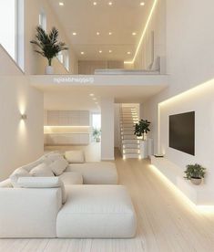 a modern living room with white furniture and stairs leading to the second floor, along with potted plants