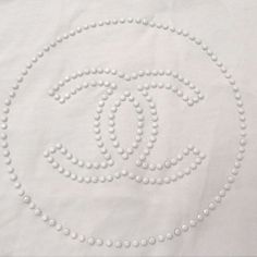 Authentic Employee Uniform Tshirt In White With Monochromatic White Beaded Cc Logo Detail On Front Center Of Shirt.. Perfect For Layering Or Wearing On Its Own ! Cotton Is Super Breathable And Fits True To Size Used As A Women’s Uniform Layering Piece But The Cut Is Def Unisex - Fit = Us Womens Lg // Men’s Md See Pics For Care And Packaging Worn But All Crystals Are Still In Tact And Dry Cleaned For You! Excellent Condition Chanel Shirts Women, Shirts For Women Chanel, Chanel Tops Shirts, Chanel Logo Sweatshirt, Chanel Tee, Chanel Logo Black Sweater Women, Chanel Shirt Graphic Tees, Chanel T Shirt, Employee Uniform