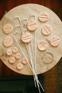 a wooden table topped with buttons and pins