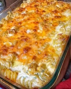 a casserole dish with pasta and cheese in a glass pan on a table