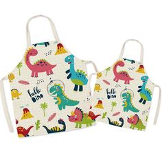 two children's aprons with dinosaurs on them