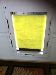 a window with yellow blinds in a room