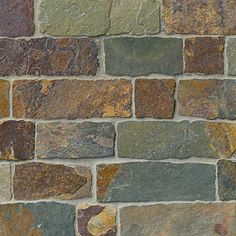 a brick wall made out of different colored stones