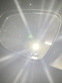 the sun shines brightly through the lens of a car's dash board cover