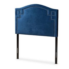 an upholstered blue headboard with studding on the sides and black legs