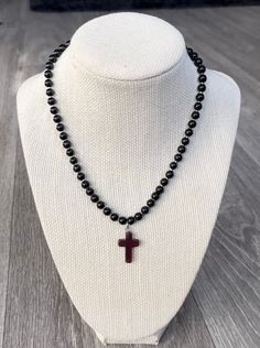 This gothic inspired piece was handmade with glass beads, a simulated amethyst glass cross charm, as well as stainless steel findings. It's super wearable and simple and made to fit everyone! It sits at 16 inches and is adjustable to 19 inches. Message me with any questions or requests! Adjustable Cross Necklace With Black Beads, Adjustable Black Beads Cross Necklace, Spiritual Black Cross Beaded Necklace, Handmade Adjustable Black Cross Necklace, Handmade Black Crucifix Necklace, Black Beaded Cross Necklaces As Gift, Beaded Spiritual Cross Pendant Necklace, Handmade Black Cross Pendant Necklace, Handmade Black Cross Necklace