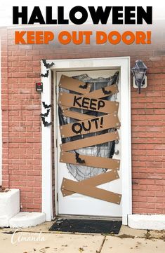 a door that has been decorated with cardboard taped to it and the words keep out