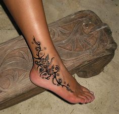 a woman's foot with a tattoo on it