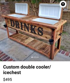 two coolers sitting on top of a wooden table with the words drinks written on it