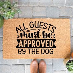 a door mat that says, all guests must be approved by the dog