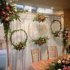 the table is set up with flowers and greenery