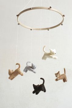 a mobile with cats and dogs hanging from it's sides