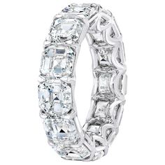 an oval and baguette cut diamond wedding ring with intricate details on the sides