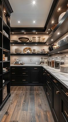 a kitchen with wooden floors and black cabinets