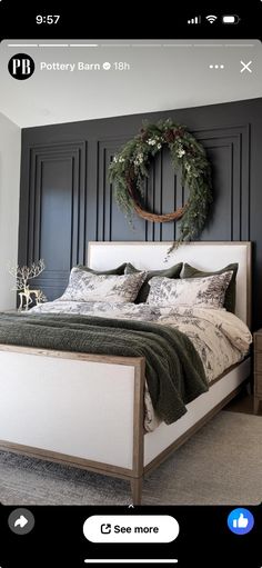 a bed with a wreath on the wall above it and an iphone app showing photos