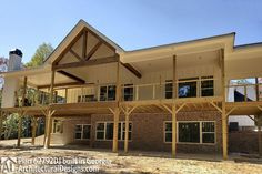 a large house with lots of windows and wood framing