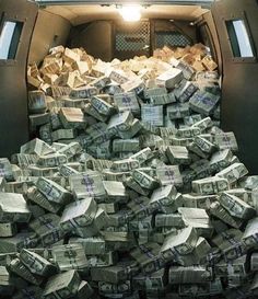 the back of a truck filled with stacks of cash