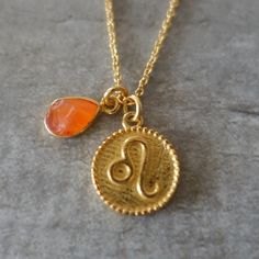 "Dear Leo,                                                                                                     your crystal is the Carnelian stone.                                                                     It promotes your creativity and ambition. You are warmhearted, generous and loyal. Keep being in love with life! Necklace with a medal of the astrological sign of Leo and pendant with a raw carnelian. Gold plated necklace, chain size 45 cm, adjustable + 5 cm. Gold plated medal engraved with the sign of Leo, dimension 1 cm in diameter. Pendant with gold plated base, raw carnelian  (unpolished) dimension 0.7 cm. Please note, natural stones are all unique and may present slight differences in color compared to the one  displayed  on this website. Your jewelry, handmade, will be se Gold Carnelian Birthstone Jewelry, Gold Carnelian Jewelry With Birthstone, Amber Amulet Necklace As Gift, Amber Birthstone Necklace For Gift, Amber Amulet Necklace For Gift, Spiritual Carnelian Gemstone Jewelry, Carnelian Gemstone Necklace As A Gift, Carnelian Gemstone Necklace For Gift, Gold Carnelian Jewelry Gift