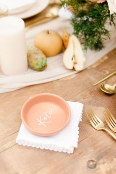 a table set with plates, forks and napkins