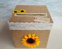 a box with sunflowers and pearls on it