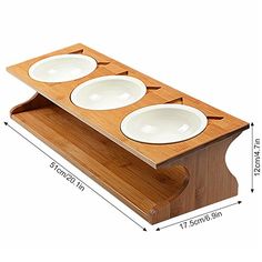 three white plates on a wooden stand with measurements for each plate in the bottom half