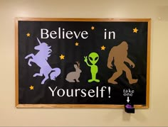 a sign that says believe in yourself, like one or two aliens and an alien