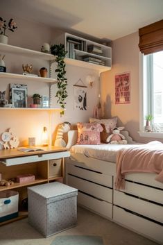 a bedroom with a bed, desk and shelves on the wall next to a window