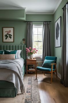 a bedroom with green walls and wooden floors is pictured in this image, there are two chairs next to the bed