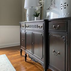 an antique dresser with two white vases on it's top and bottom drawers