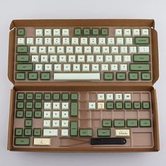 an old computer keyboard in a wooden case