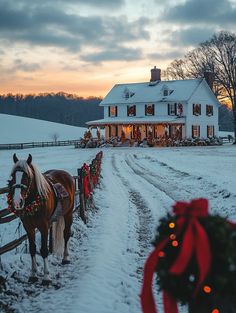 a horse that is standing in the snow next to a fence with christmas lights on it