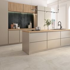 a large kitchen with wooden floors and white walls