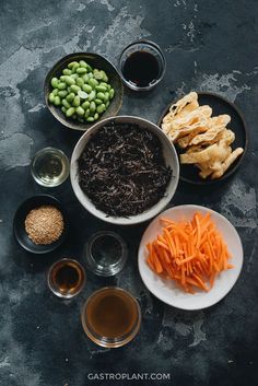 various foods are arranged in bowls on a table