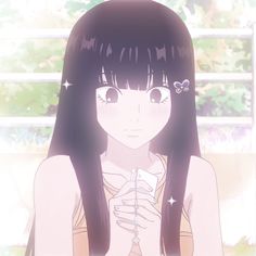 a girl with long black hair holding a cell phone