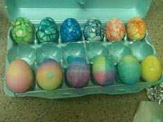 an egg carton filled with different colored eggs