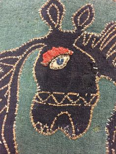 a close up of a piece of cloth with an animal on it's face