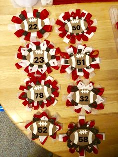 the table is decorated with red, white and brown paper plates that have footballs on them