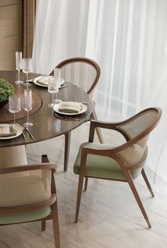 a dining table with chairs and plates on it