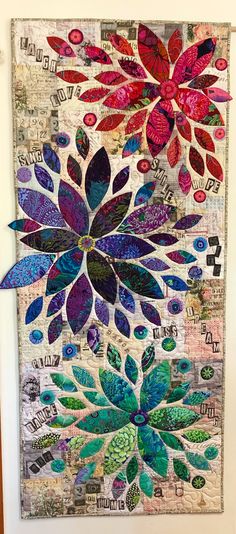 a colorful quilt hanging on the wall