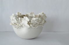 a white bowl filled with whipped cream on top of a table