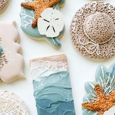 decorated cookies are arranged on a white surface