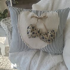 a decorative pillow with two hearts on it