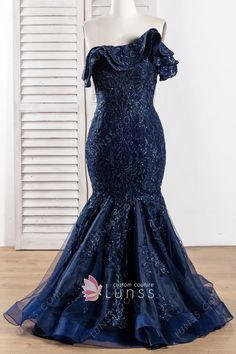 an off the shoulder navy blue evening gown with ruffles and beading on it