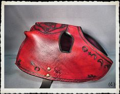 This unique and fully handmade mask is made of 6-7 oz veg tanned leather dyed red, treated with a leather satin acrylic finisher. The mask is adorned with punched patterns and alchemist symbols. The leather strap have a buckle made from steel and antique bronze plated. It's long enough to any size of head or top hat, attached to the frame with bronze plated rivets. Extralong straps are available, just ask for it. If you have any question or want something similar, feel free to ask! Please take a Handmade Red Masks And Prosthetics For Masquerade, Alchemist Symbols, Leather Bracers, Handmade Mask, Costume Masks, Half Mask, Leather Mask, Leather Dye, Veg Tan Leather