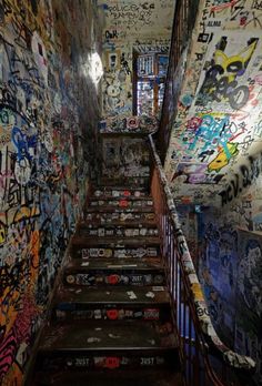 the stairs are covered with graffiti and stickers